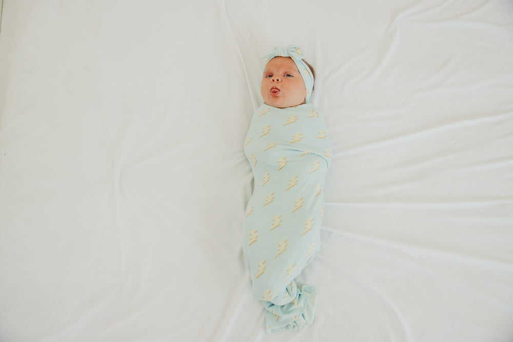 Copper Pearl baby swaddle blanket unisex print communicates modern baby style.