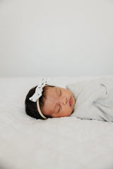 Copper Pearl Willow bow paired with matching swaddles for gift-ready presentation