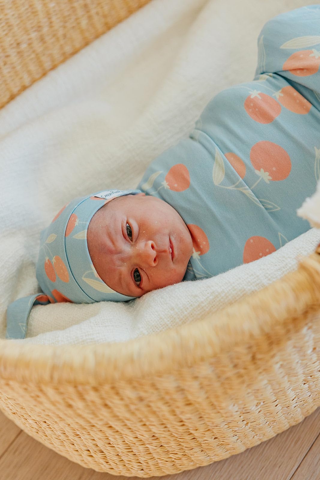 Copper Pearl Clementine swaddle care-instructions guide highlights machine-washability and durability.