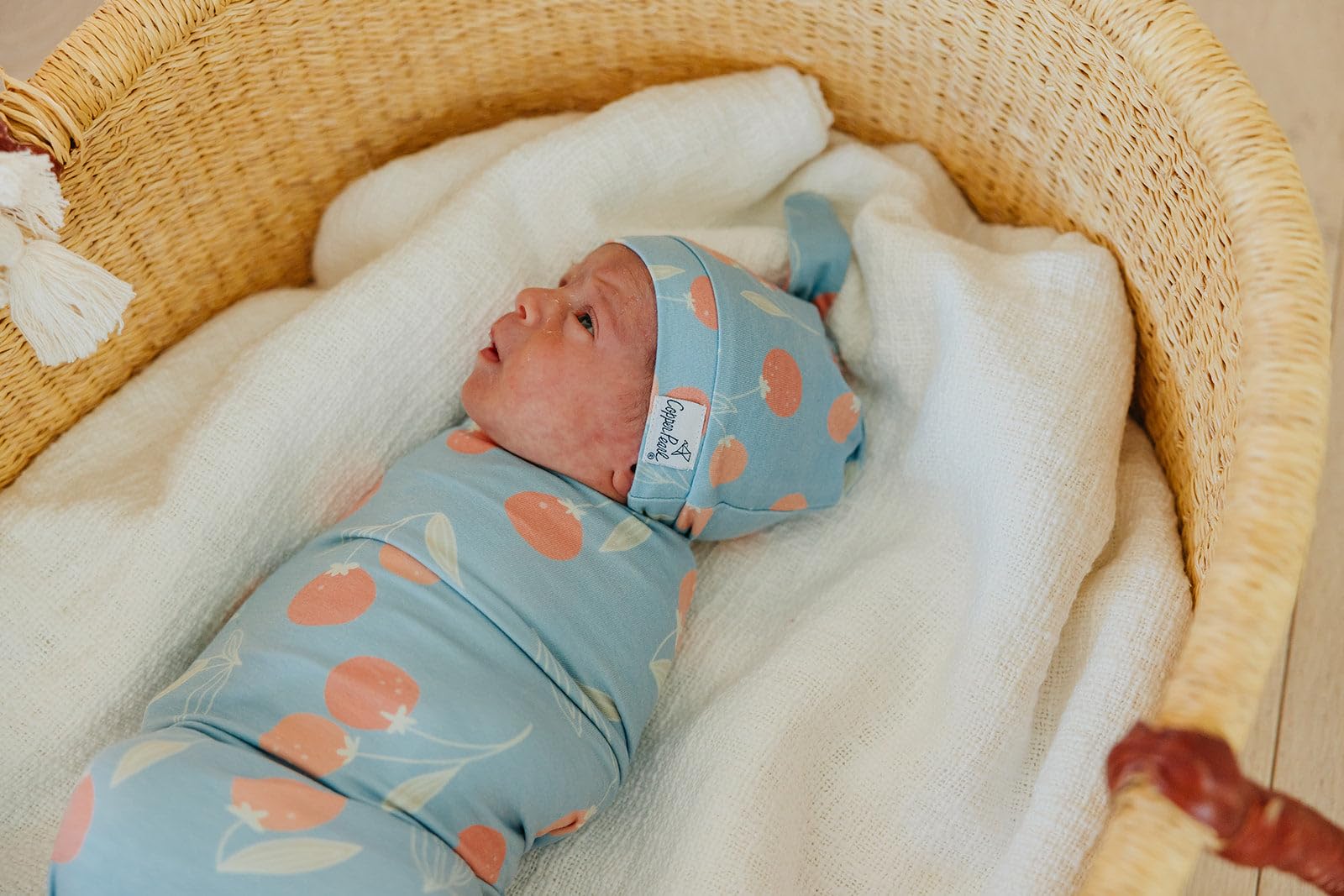 Copper Pearl Clementine swaddle fashion-print emphasizes stylish baby outfits coordination.