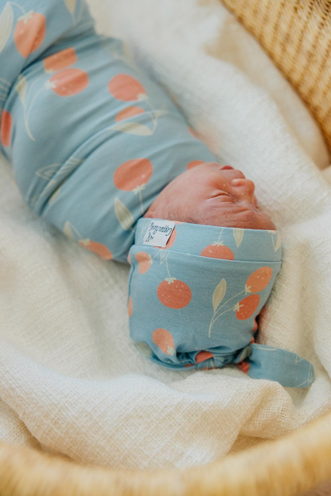 Copper Pearl Clementine swaddle gift-ready packaging appeals to baby shower registries.