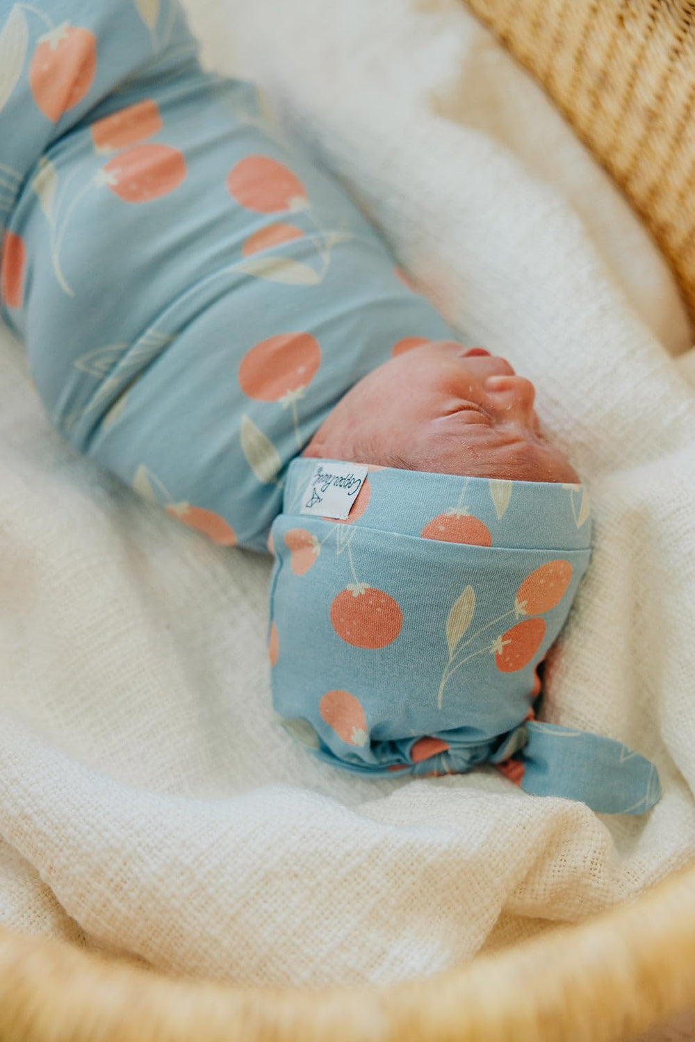 Copper Pearl Clementine swaddle gift-ready packaging appeals to baby shower registries.