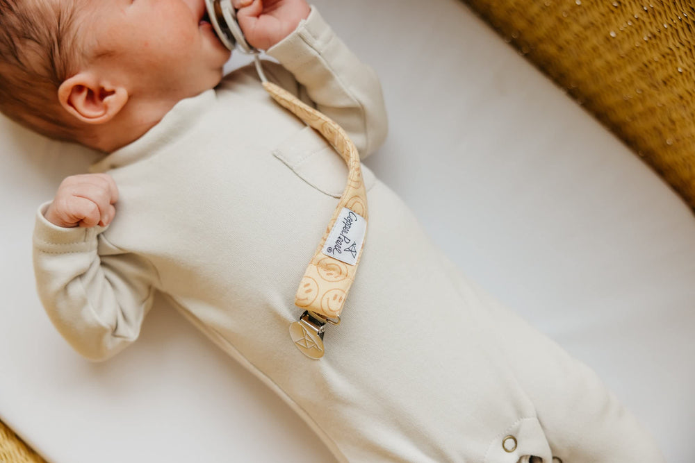Copper Pearl clip in diaper bag scene highlights easy access during outings.