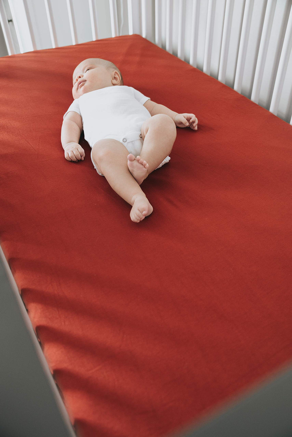 Copper Pearl crib sheet shows elastic stitching for a tidy, secure look