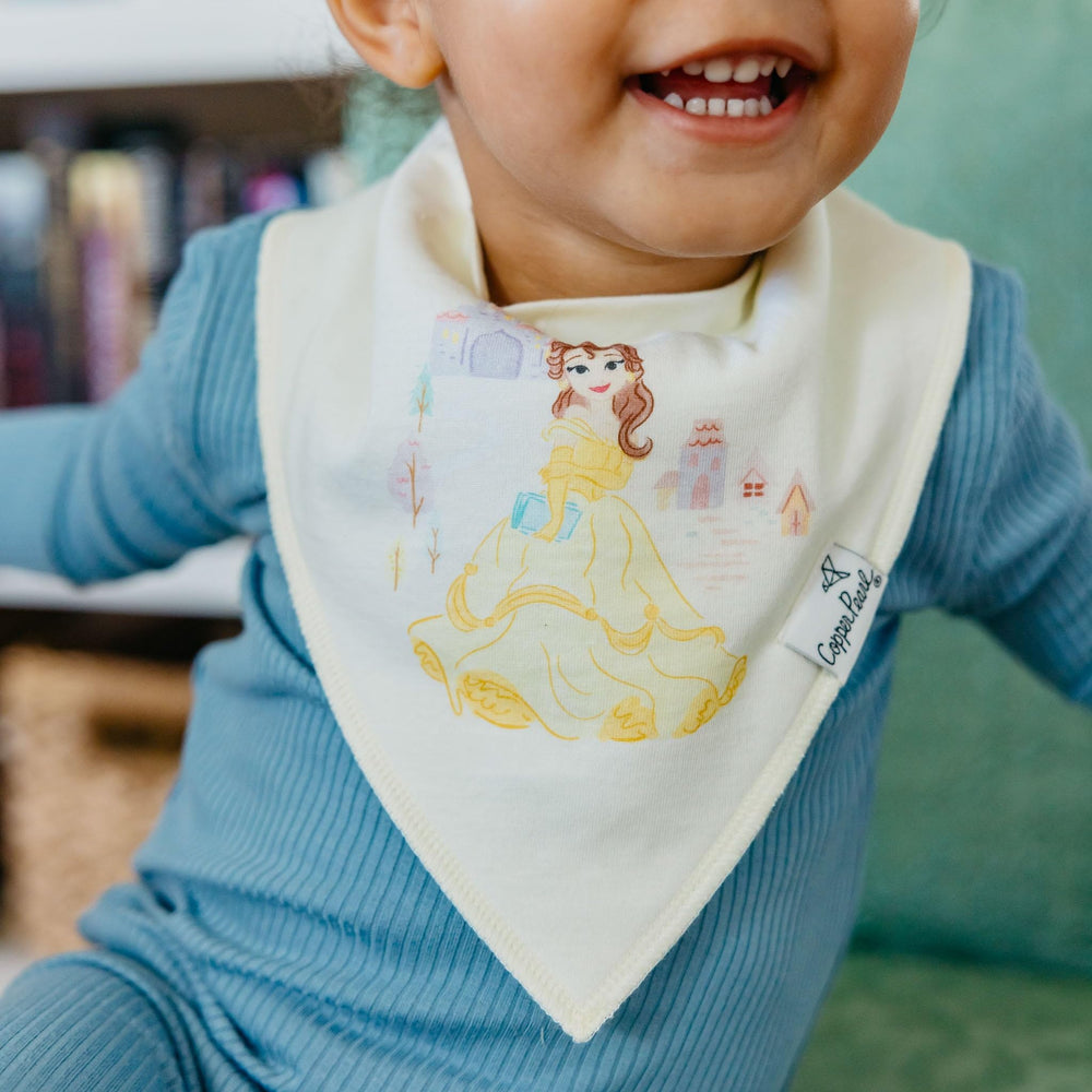 Copper Pearl Disney Princess design motif on bandana bib, arranged with baby outfits for chic styling