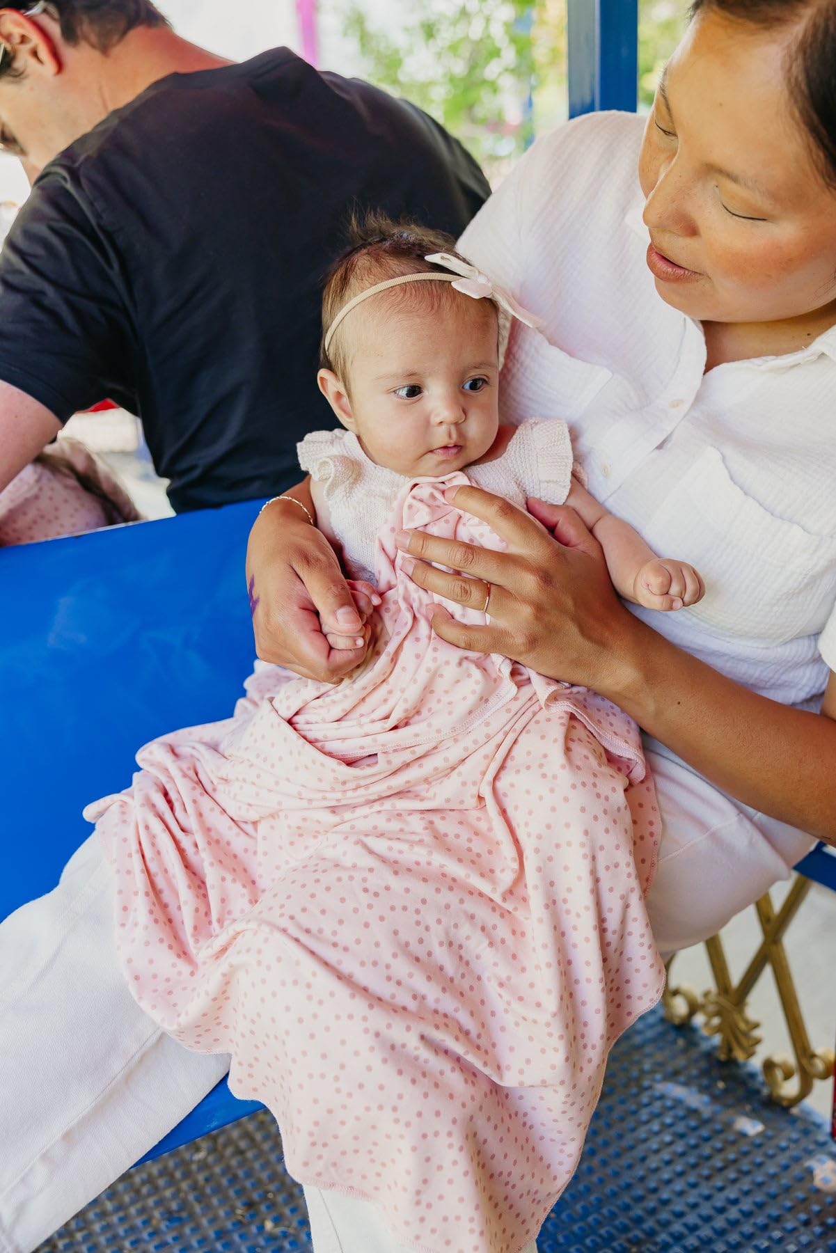 Copper Pearl Dottie swaddle blanket doubles as stroller shield on outings.