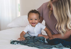 Copper Pearl Hunter swaddle blanket used as nursing cover for discreet feeding.