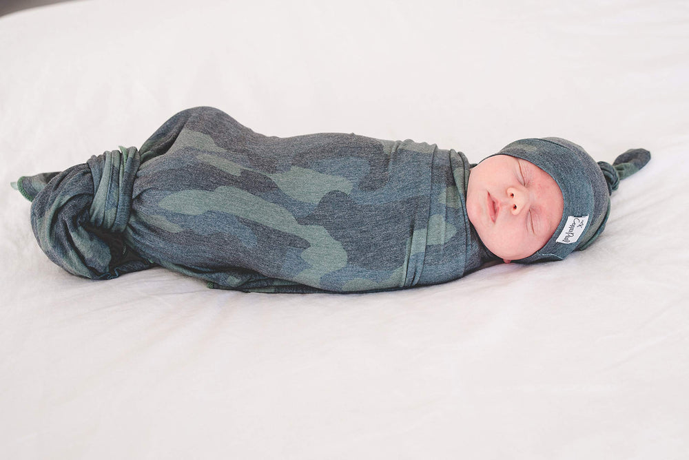 Copper Pearl Hunter swaddle blanket laid on stroller for shield from sun and wind.