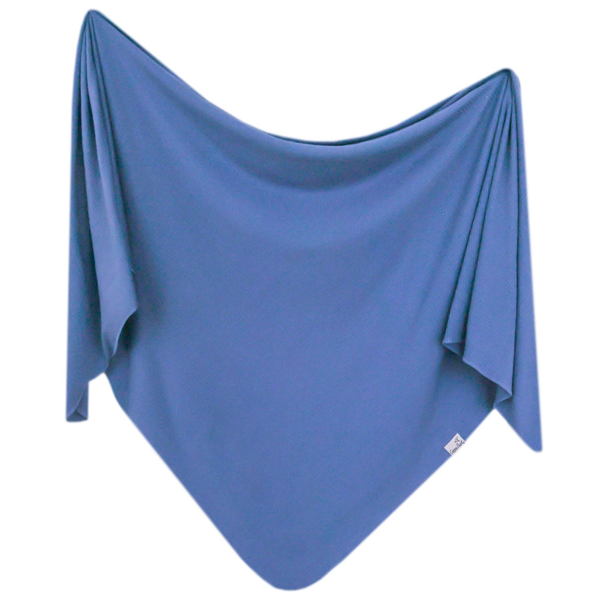 Copper Pearl Indigo swaddle blanket 46in on bed showing size and cozy warmth