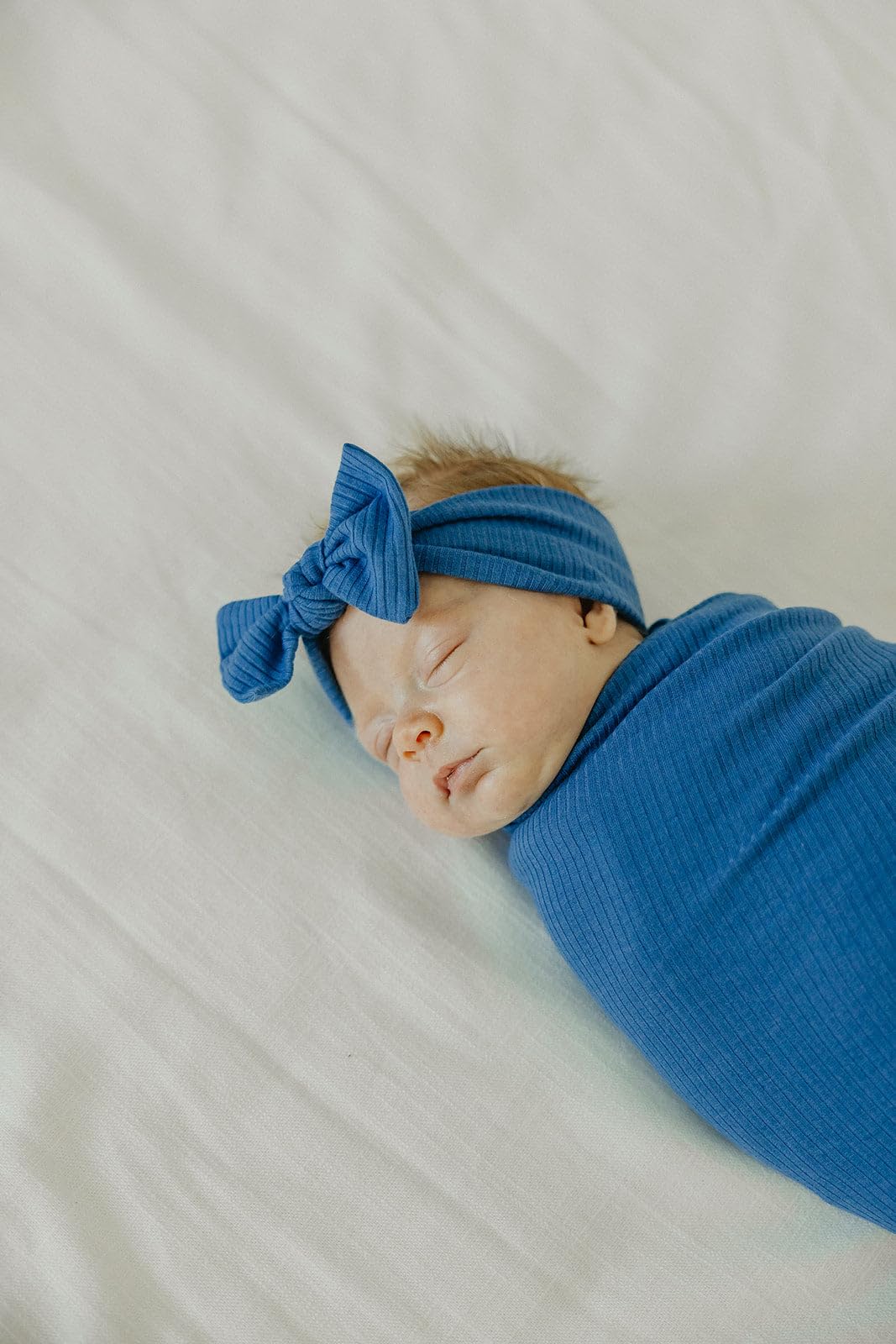 Copper Pearl Indigo swaddle shown with accessories for coordinated baby outfits