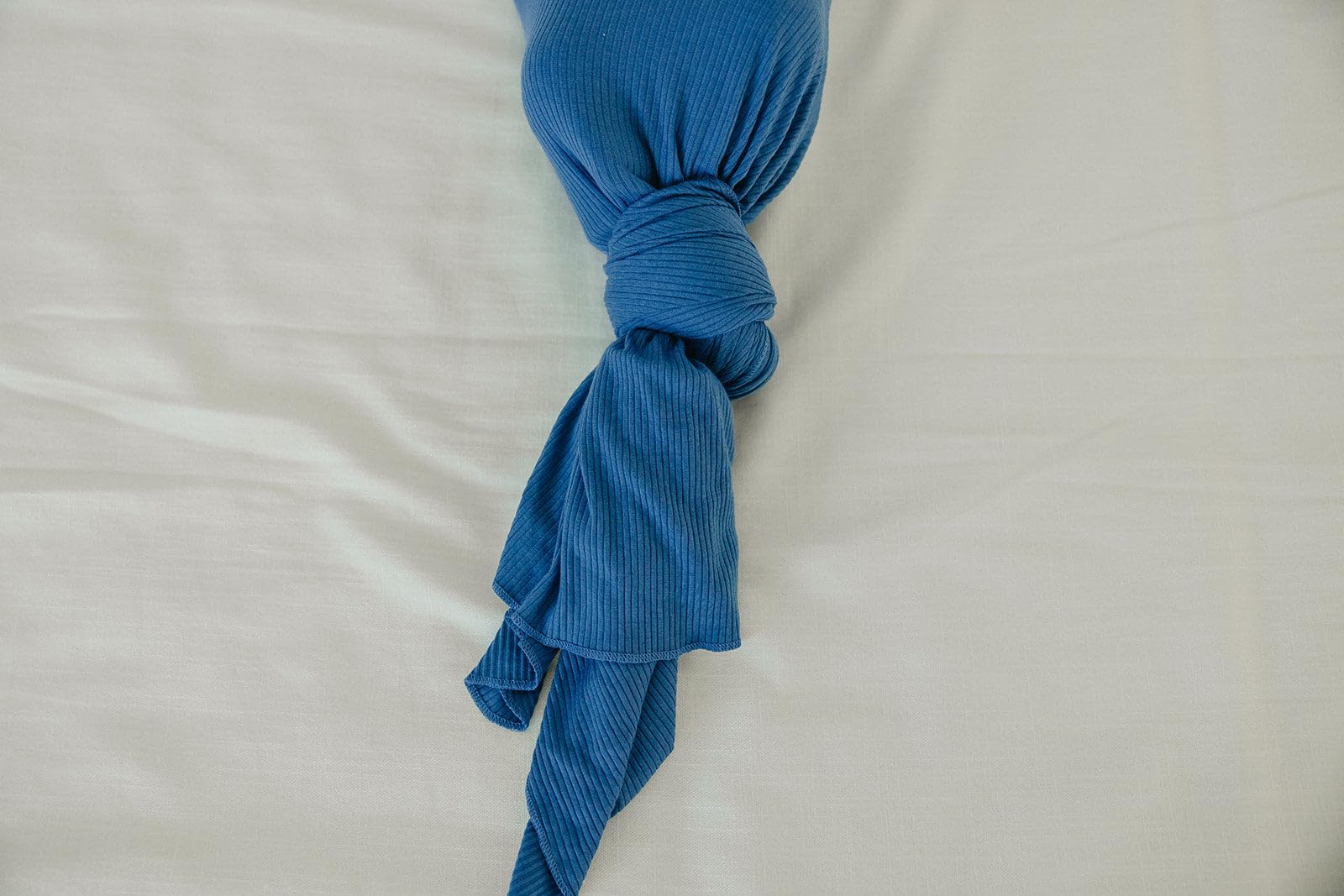 Copper Pearl Indigo swaddle detail highlights delicate stitching and durable softness