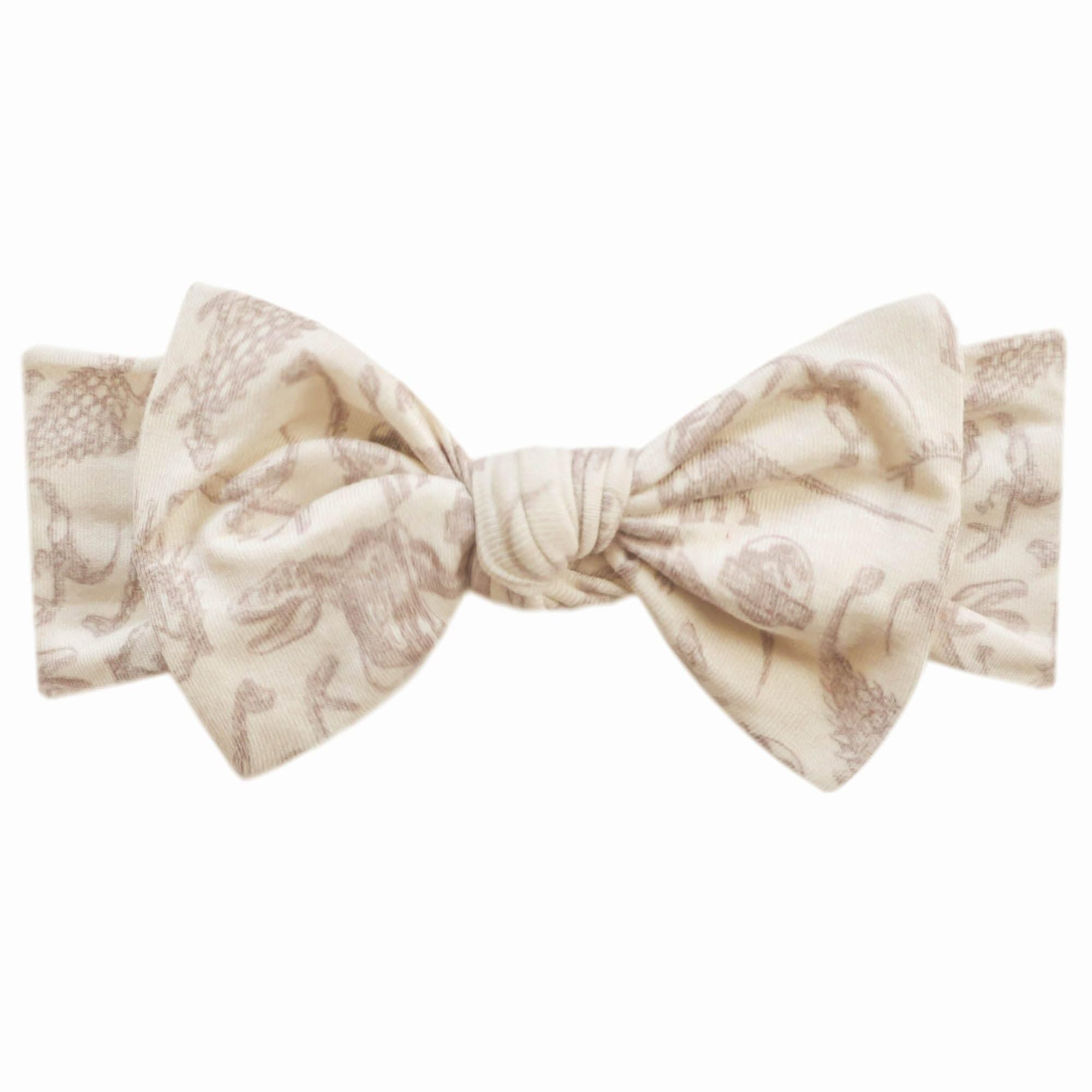 Copper Pearl Jurassic Park Fossils headband shown on a newborn for everyday wear