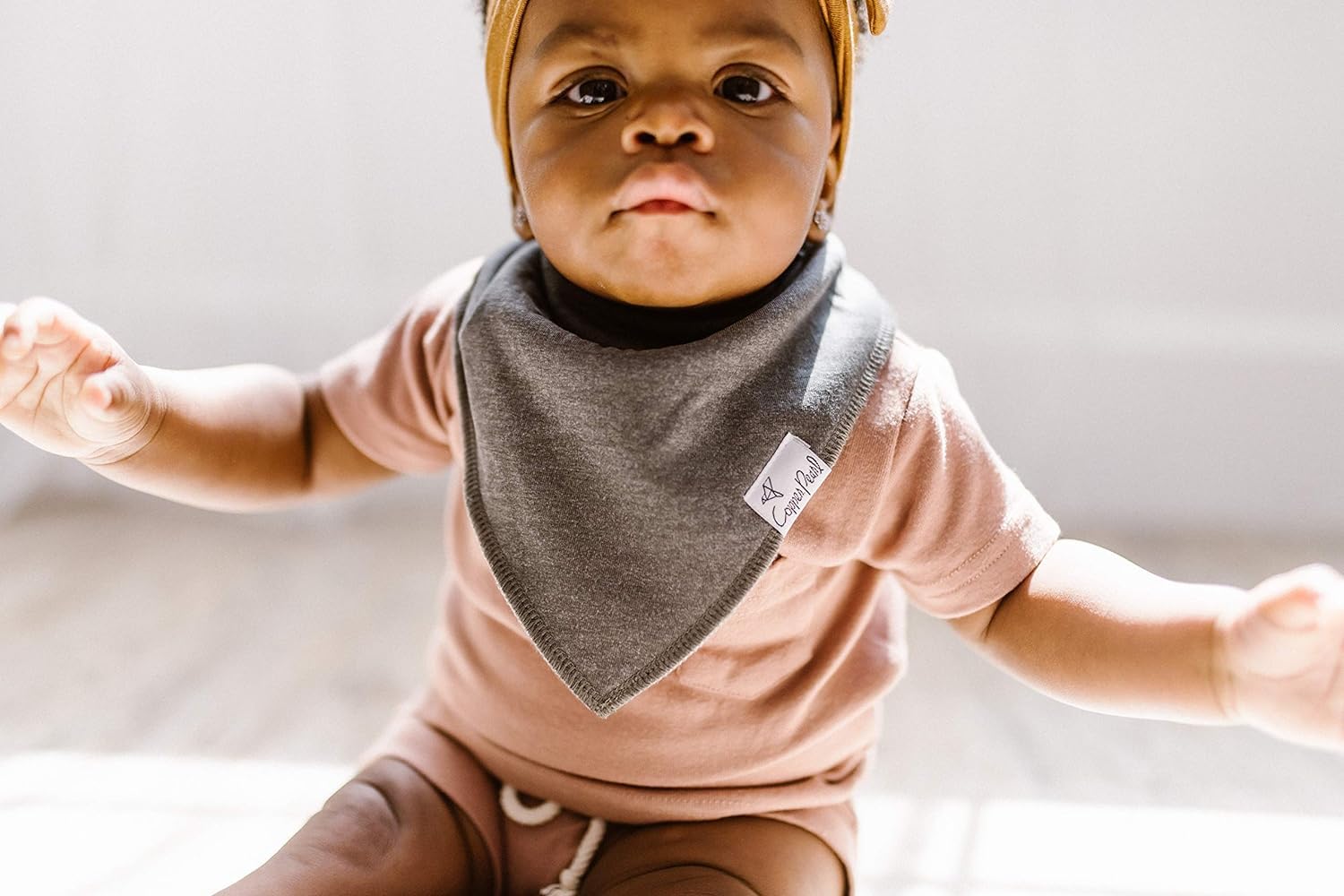 Copper Pearl Lennon bib styles on baby demonstrate versatile outfits and fashion.