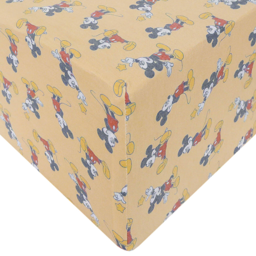 Copper Pearl Mickey Mouse knit crib sheet closeup shows ultra-soft fabric for baby's comfort.