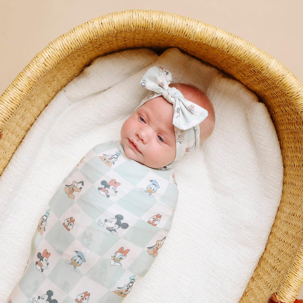 Copper Pearl Mickey Mouse & Friends swaddle blanket during tummy time—gentle support and play