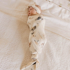 Copper Pearl Montana swaddle blanket on baby for snug swaddling