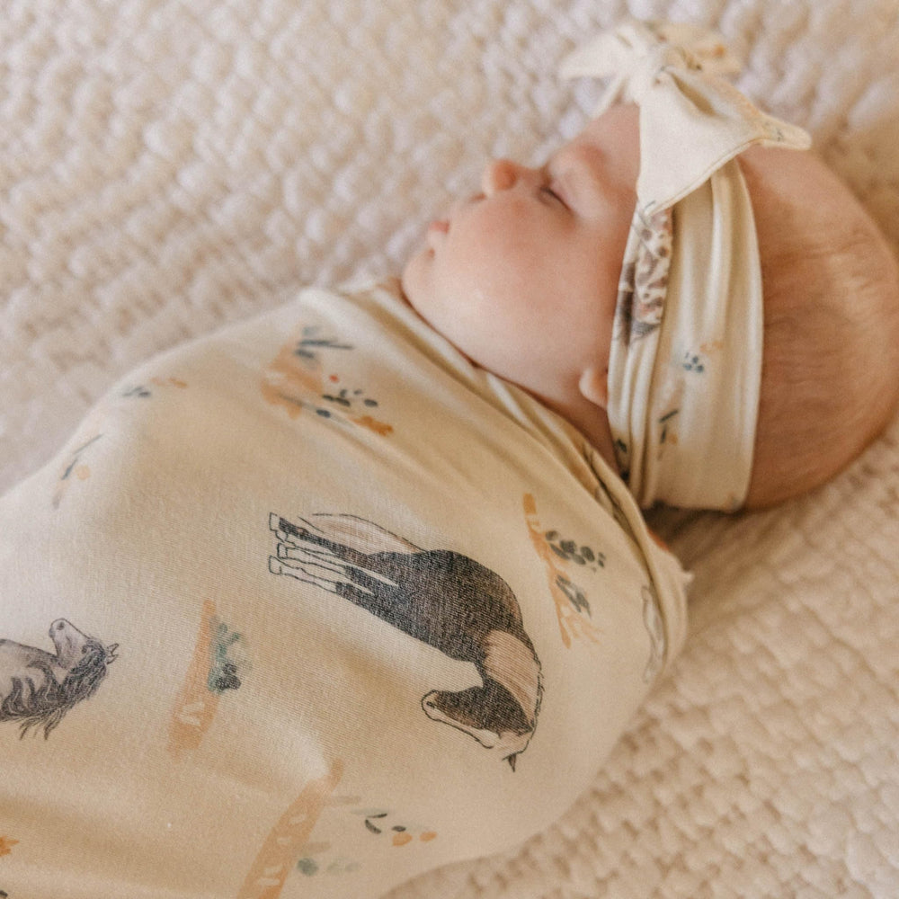 Copper Pearl Montana swaddle used as a playmat for floor time