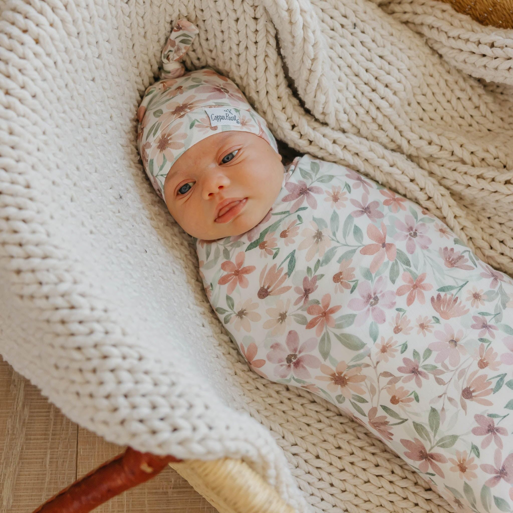 Copper Pearl Natalie Knit Blanket Single draped as a soft baby wrap for warmth