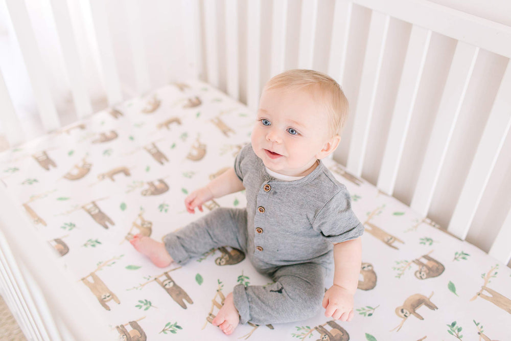 Copper Pearl Noah baby sleeping on premium knit crib sheet