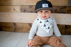 Copper Pearl Phoenix bib on baby girl outfit enhances stylish look.
