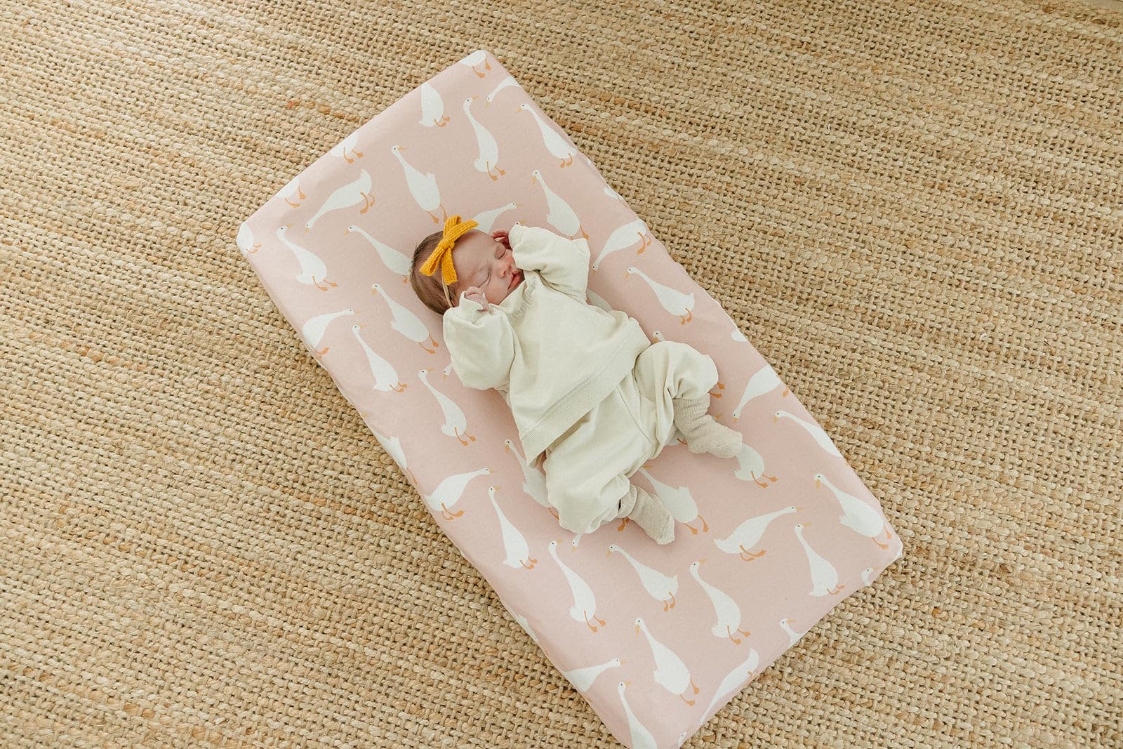 Copper Pearl Premium Knit Changing Pad Cover on changing pad in cozy nursery scene