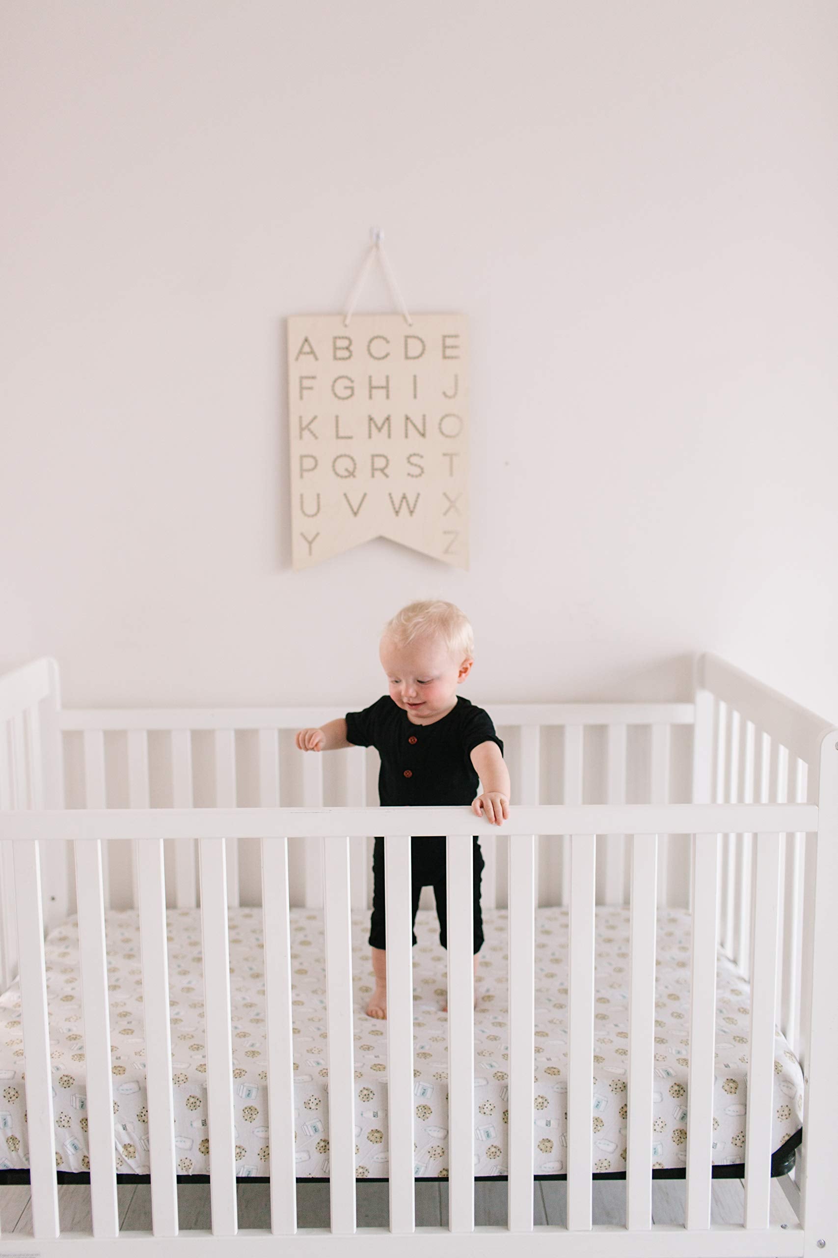 Copper Pearl crib sheet in-use demonstrates breathable knit fabric during sleep transitions