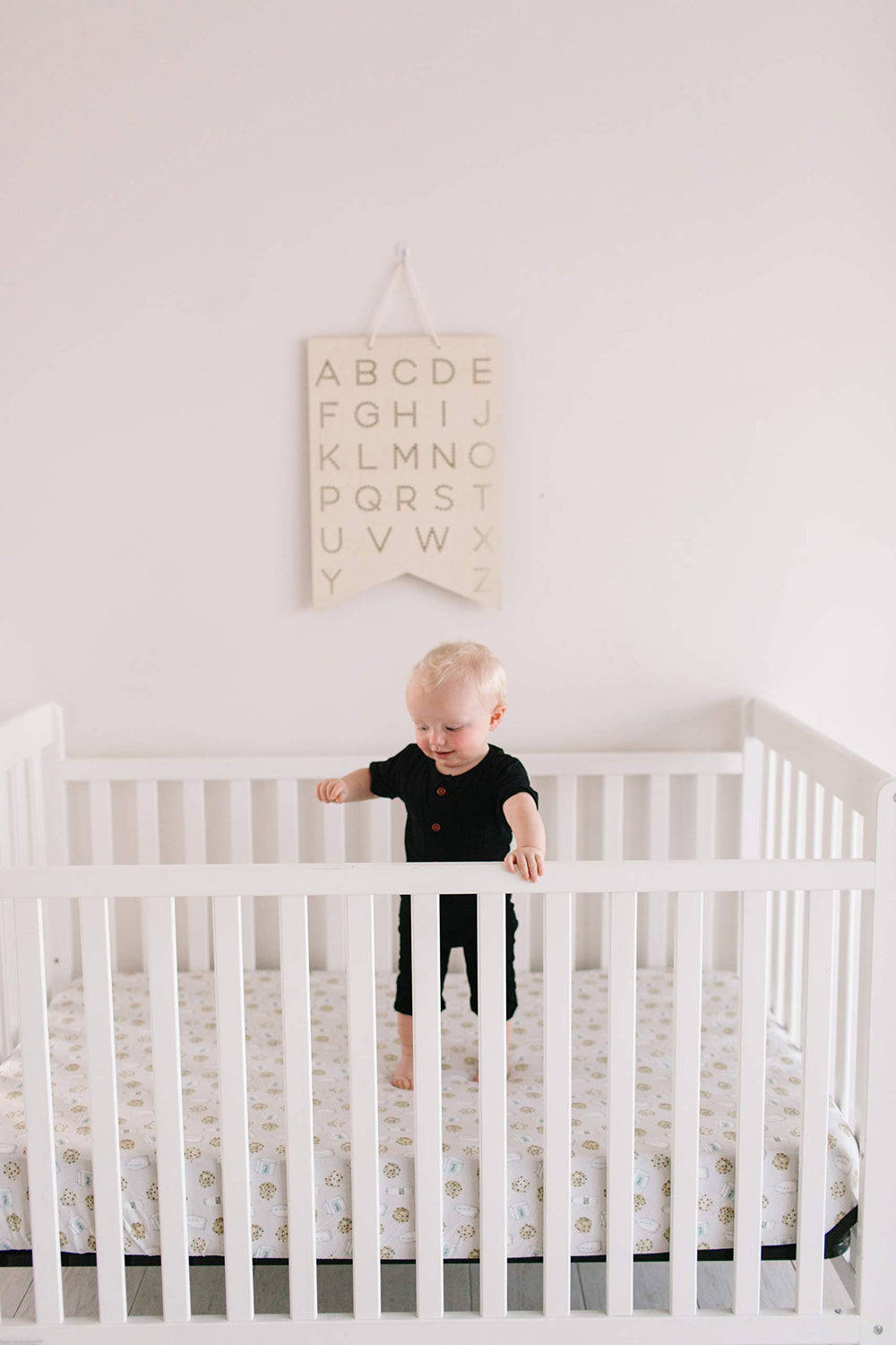 Copper Pearl crib sheet in-use demonstrates breathable knit fabric during sleep transitions