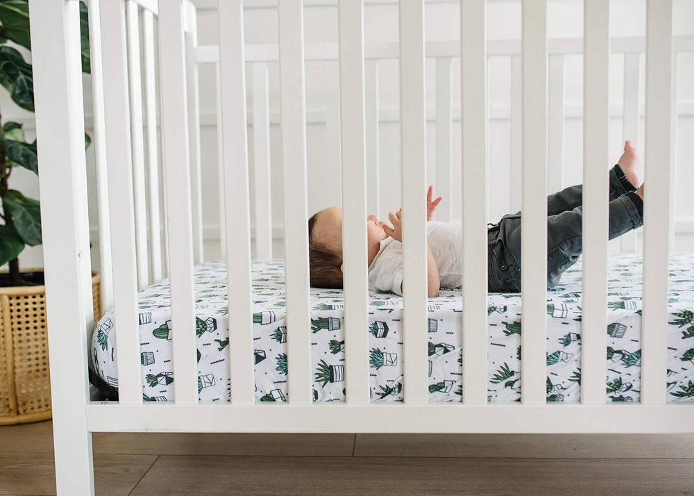 Copper Pearl Shiloh knit crib sheet on standard mattress with secure fit.