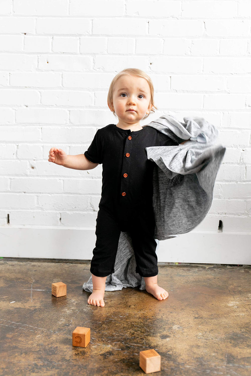 Copper Pearl Asher swaddle blanket in use demonstrates snug wrap during infant calm moments.