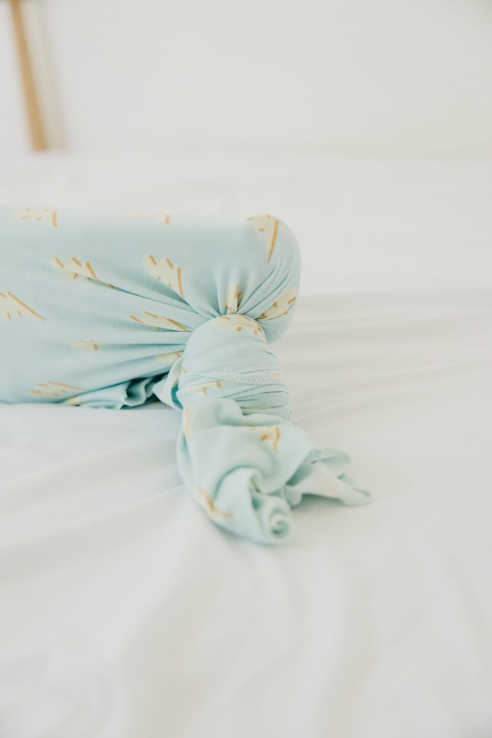 Copper Pearl swaddle blanket stroller shield shows practical protection during outings.