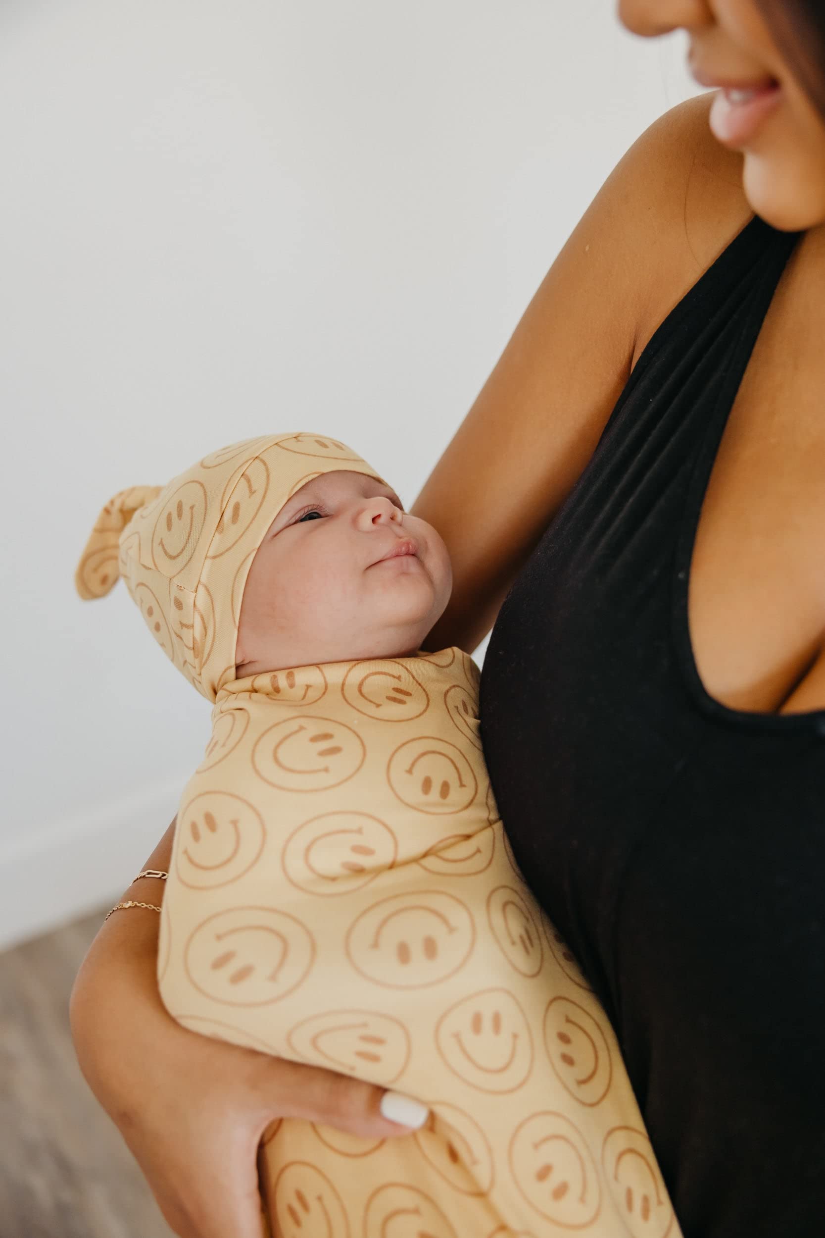 Copper Pearl swaddle blanket shields baby in stroller on sunny days.