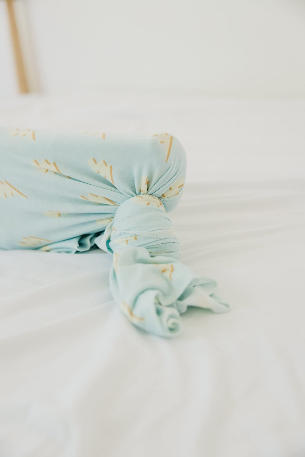 Copper Pearl swaddle blanket stroller shield shows practical protection during outings.