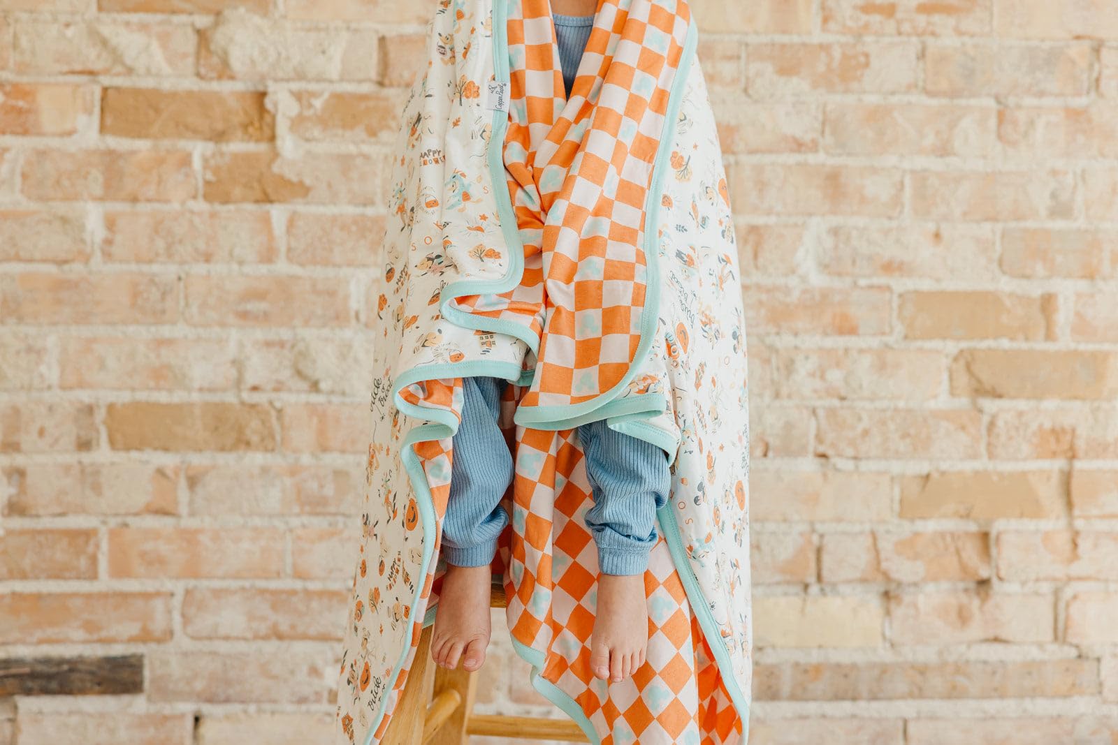 Copper Pearl three-layer knit blanket detail highlighting durable serged edges