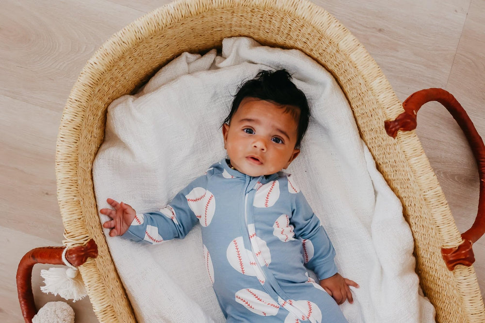 Copper Pearl zip-up footie pajama trendy prints image suggests stylish baby outfits.
