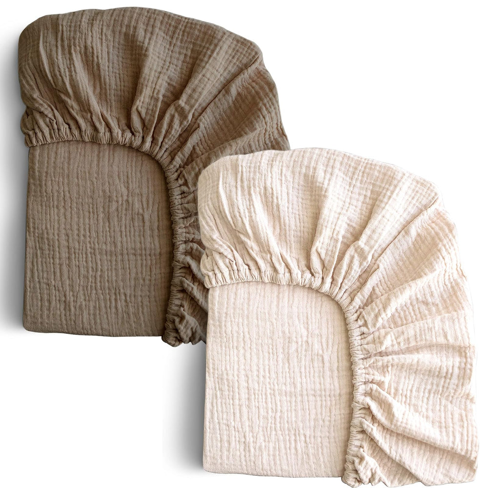 COSMOPLUS Muslin crib sheets in ivory on a standard crib mattress with a snug, secure fit.