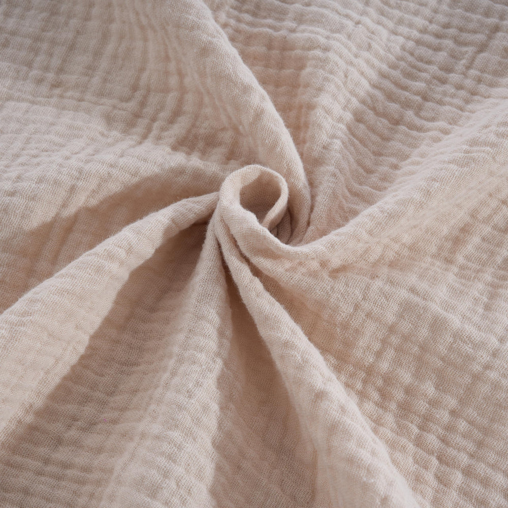 CottCare baby muslin swaddle rose pink wrapped newborn demonstrates secure, cozy wrapping.