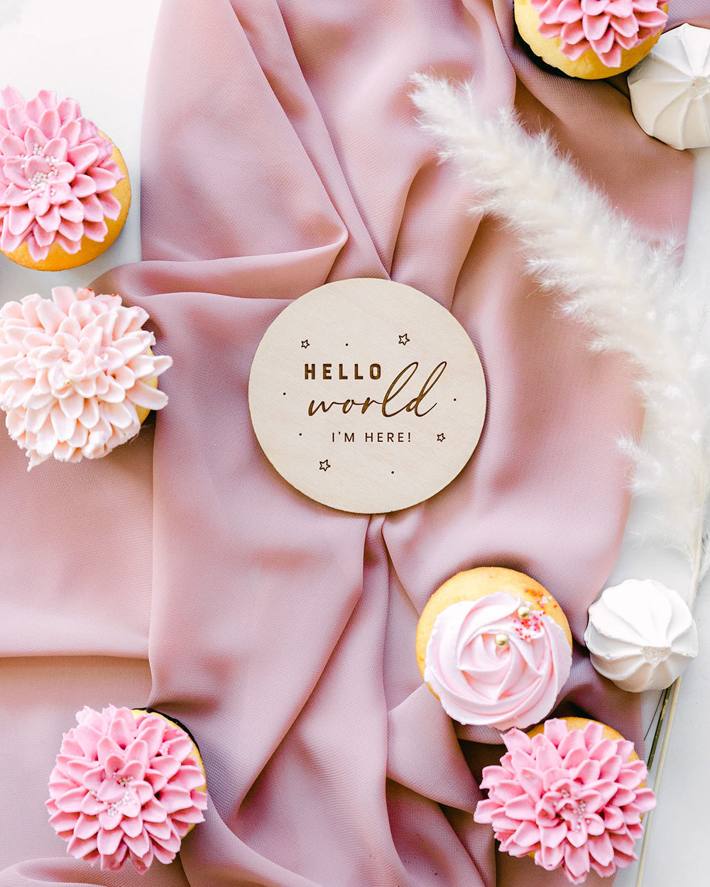 The Cotton & Canvas Co laser-engraved baby-name disc serves as a timeless birth-announcement keepsake.