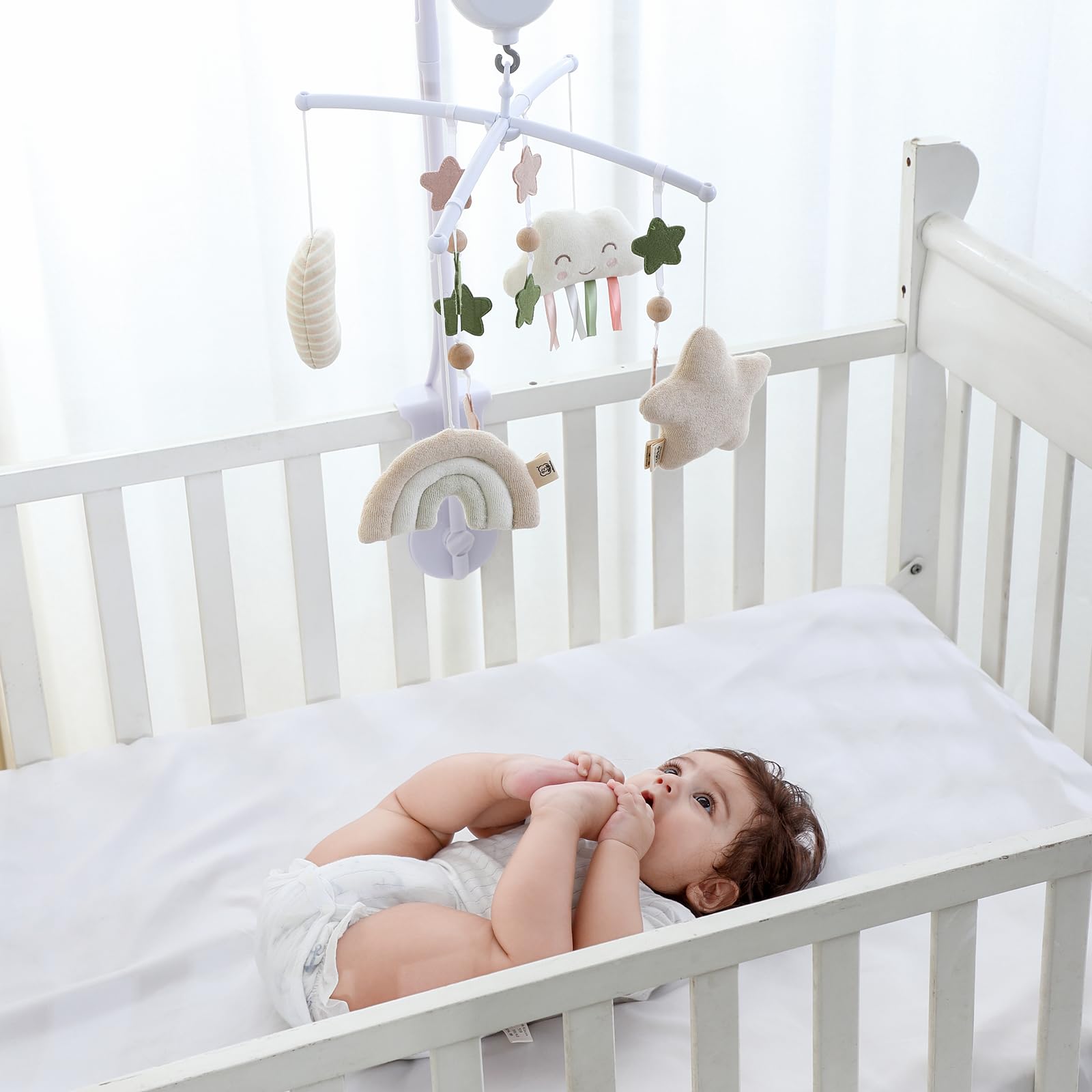 COTTONBEBE crib mobile music control allows tune selection and auto-stop.
