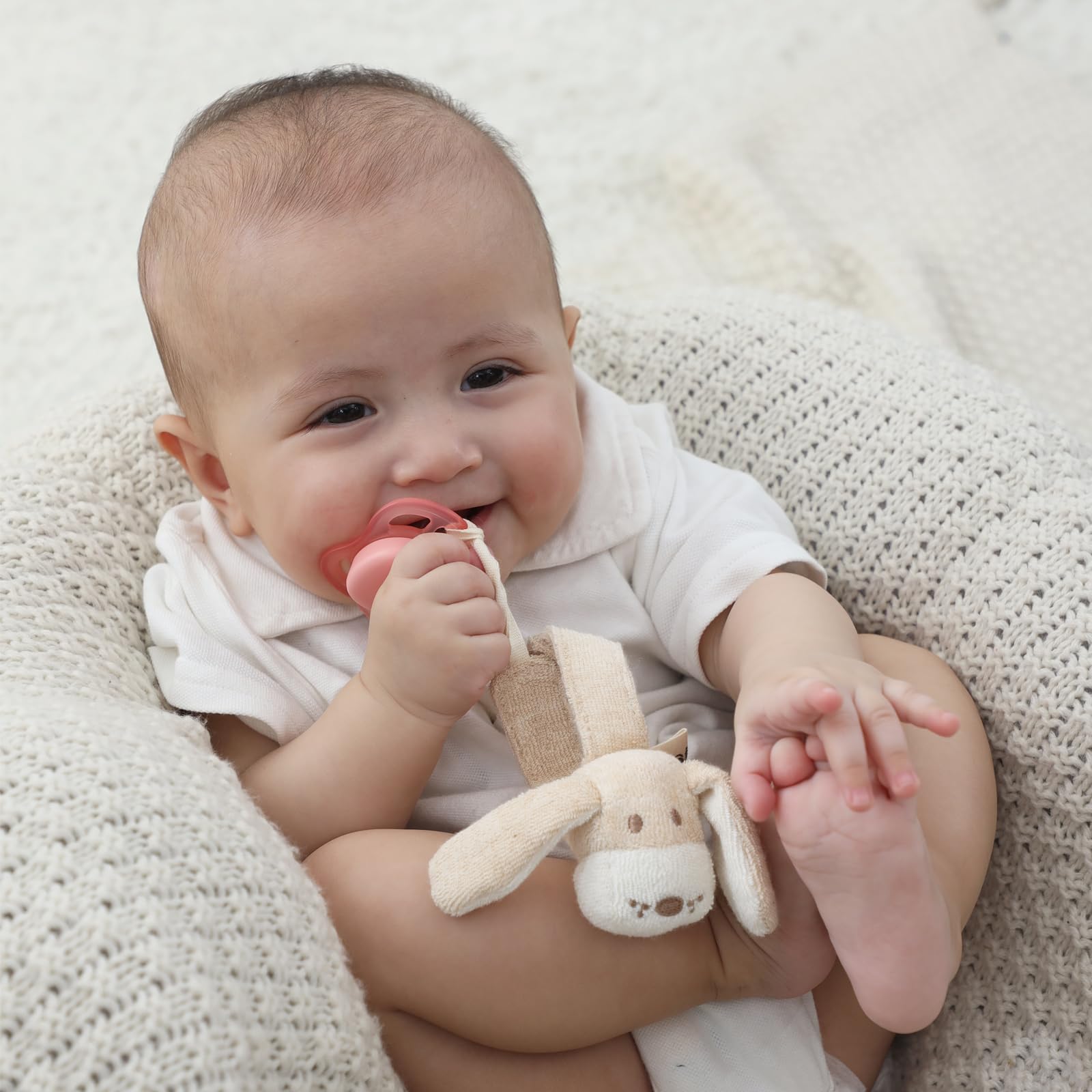 Cottonbebe pacifier clip attached to clothes or stroller for on-the-go use.