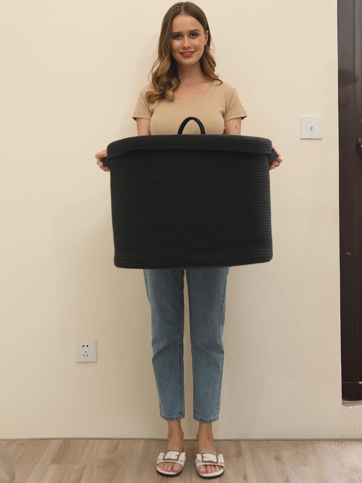 Cottonphant storage basket used for blankets and towels in bedroom