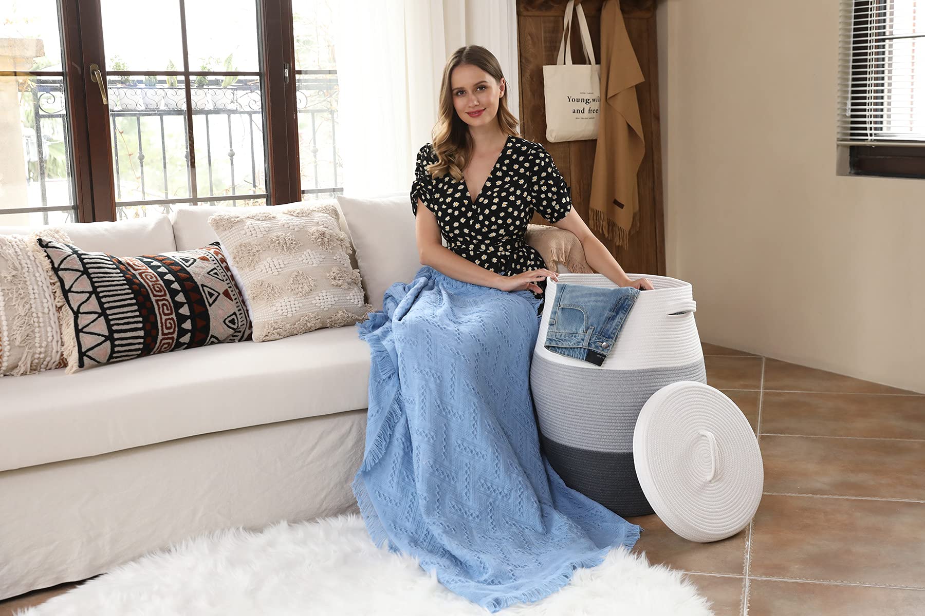 Elegant storage basket in living room for blankets and magazines.