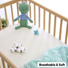 Cottonsis muslin baby crib sheet folded minty green highlights gentle cooling comfort for summer nights.