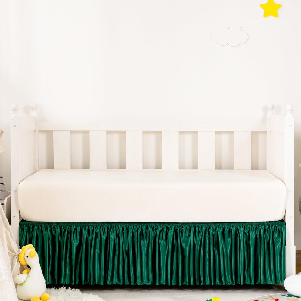 Counfeisly Blackish Green Satin Crib Skirt on bed offers silky touch for baby comfort.