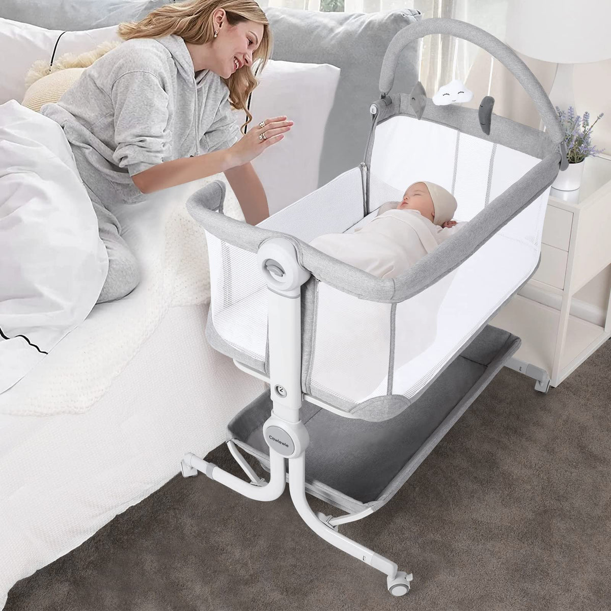 Cowiewie Baby Bassinet beside bed with wheels for easy nighttime access.