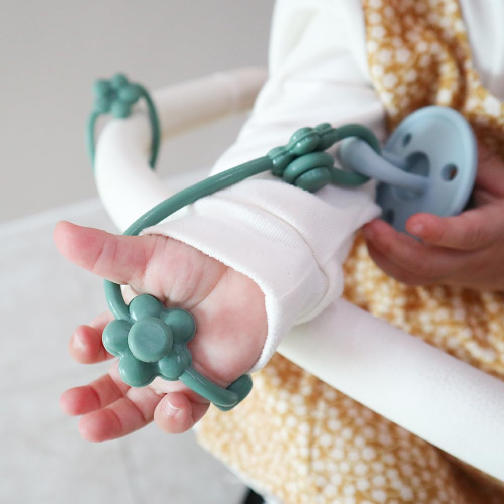CuddleCubs bright-beige set on soft surface highlights versatile teether trio.