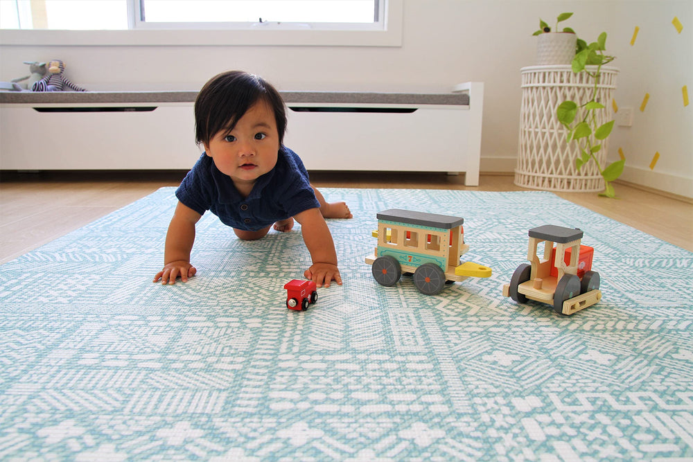 Cushmat reversible-foam-play-mat coral-teal side shown enhances kids room aesthetics.