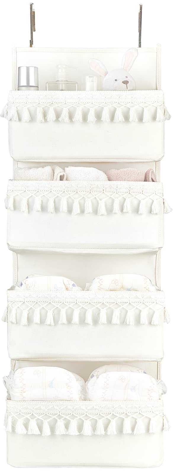 Dahey over the door organizer with white tassels keeps nursery clutter neatly organized.