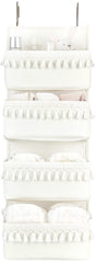Dahey over the door organizer with white tassels keeps nursery clutter neatly organized.
