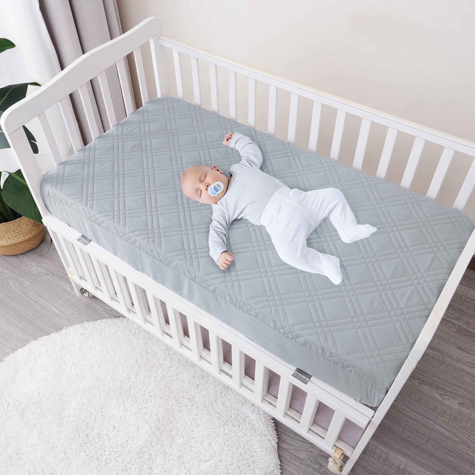 David's Kids crib protector on-mattress shows secure 360° elastic skirt for snug fit.
