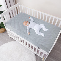 David's Kids crib protector on-mattress shows secure 360° elastic skirt for snug fit.